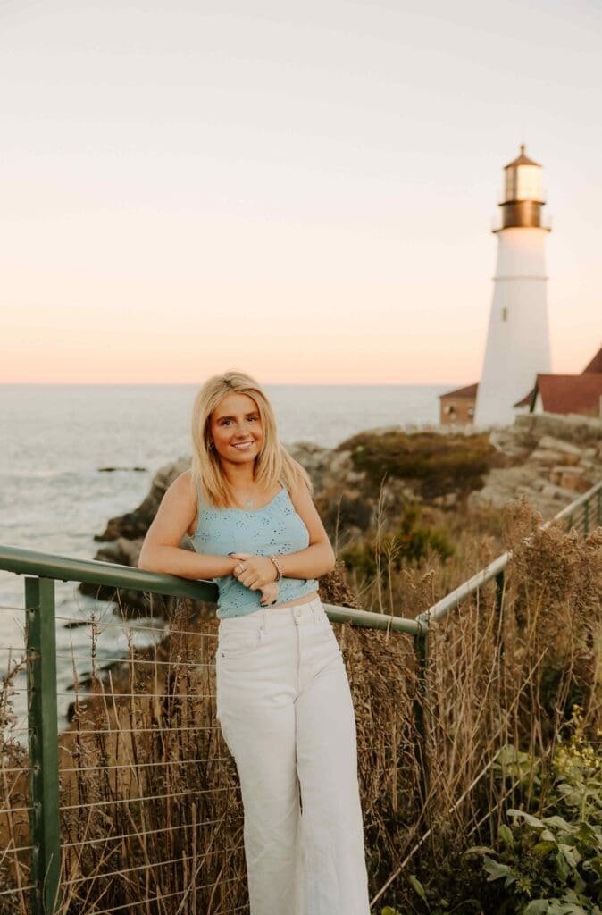 girl in front of the portland headlight in maine