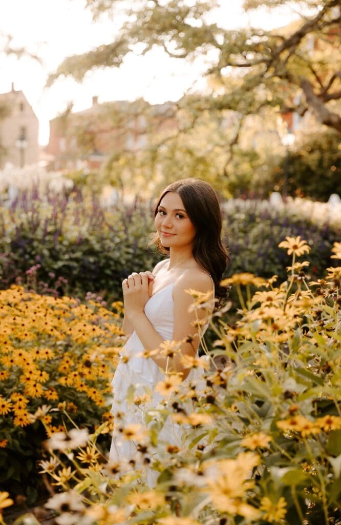 girl standing in a flower garden