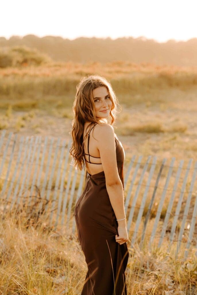girl walking away from camera in a field